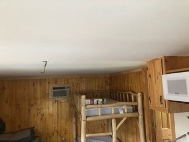 Wood-paneled interior room before a full handyman renovation.