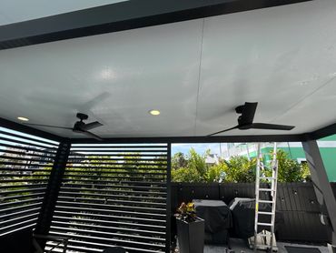 Covered lanai upgraded with ceiling fans, lighting and outdoor sun shades.