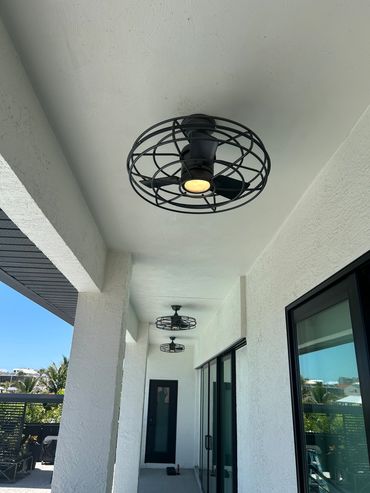 Decorative ceiling light fixture installed in a covered home entry.
