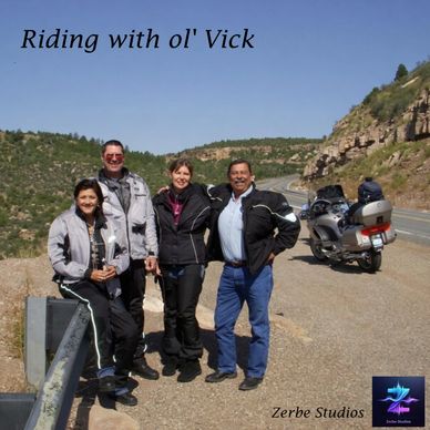 Group of four motorcyclists posing on a scenic road.