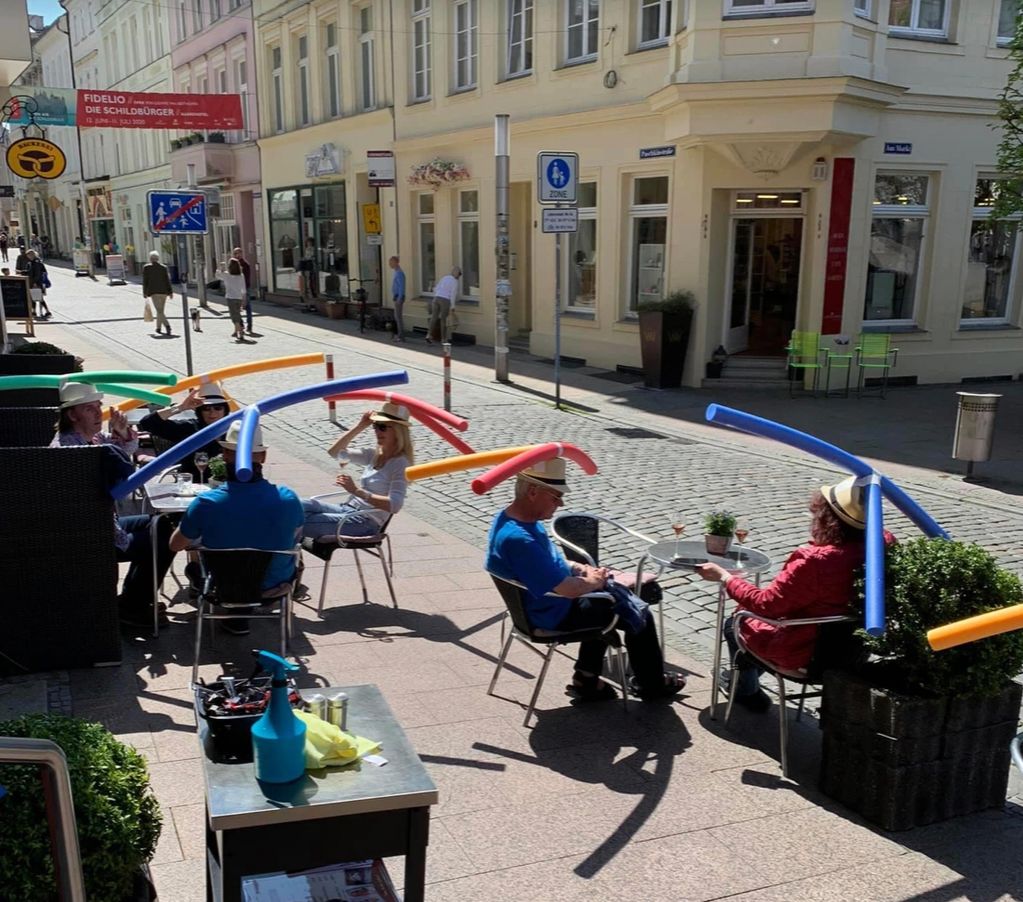A café in Germany celebrated reopening by giving patrons hats with pool noodles to keep them apart