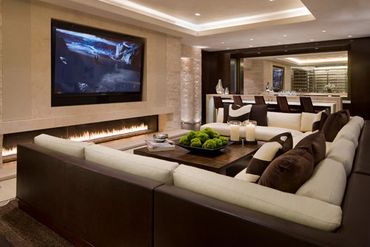 Modern living room with a large sectional sofa and wall-mounted TV.