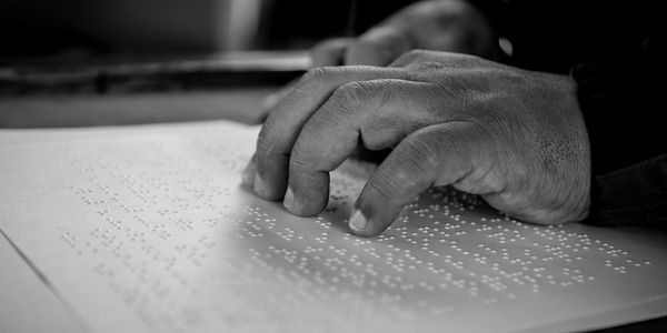A man reading braille