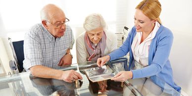 nursuring woman with two older people looking at the photos
