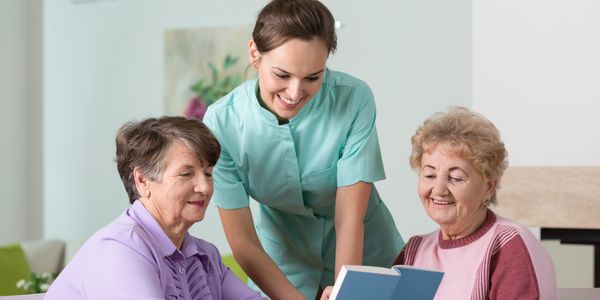 2 older woman read to nurcery yung woman