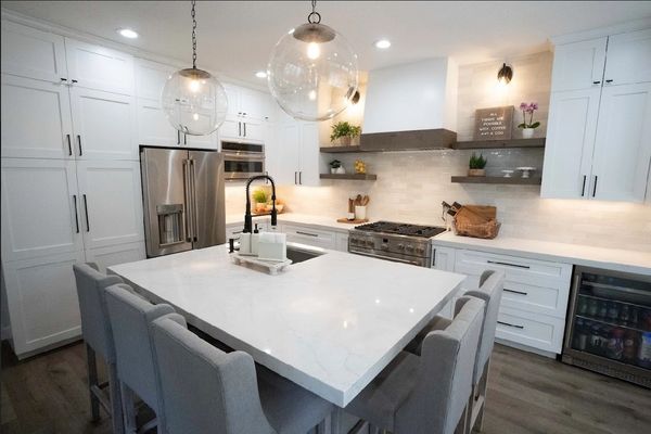 Custom kitchen cabinets with concealed appliances and floating wood shelves