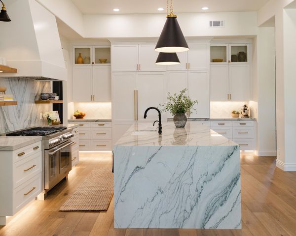 Custom cabinets, hood vent and wood floating shelves with lighting.