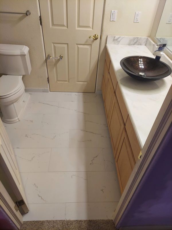 After picture of bathroom floor complete tile removal and replacement