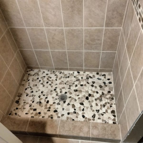After old mosaic tile floor was removed and new tile was installed in its place