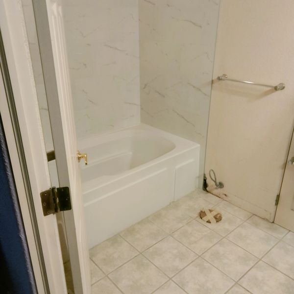 Before the tile floor was removed and replaced with new tiles to match the shower a