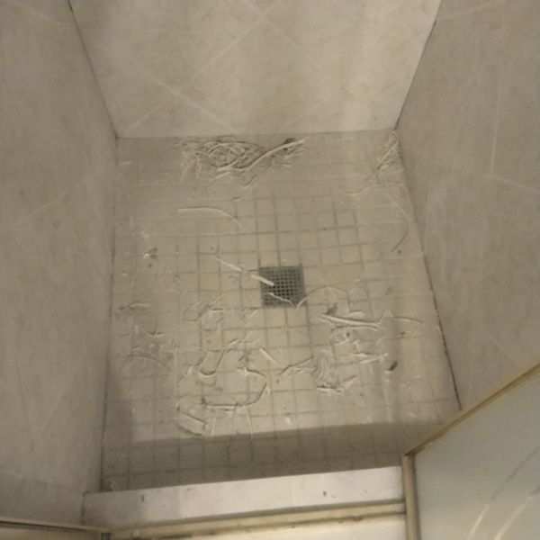 SHOWER AFTER OLD CAULK WAS REMOVED BEFORE REPLACING CAULK AND GROUT DYING