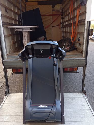 Removing various kinds of gym equipment,from a closing gym to a new opening gym.