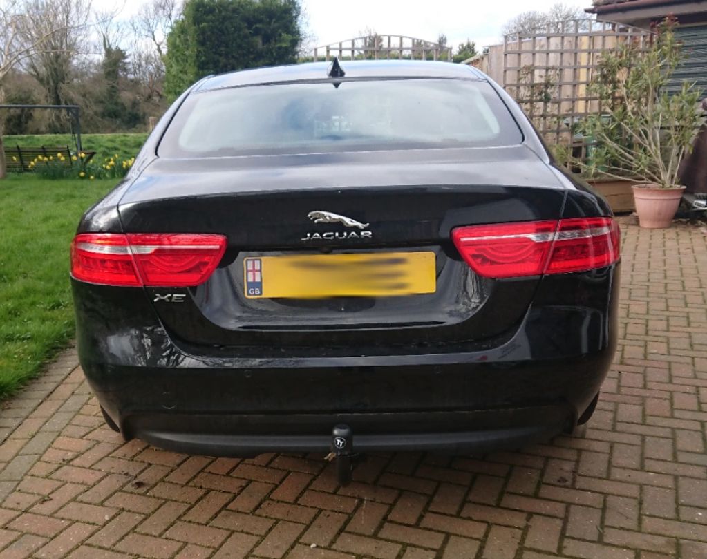 Black Jaguar XE fitted with a detachable Tow-Trust Tow Bar 