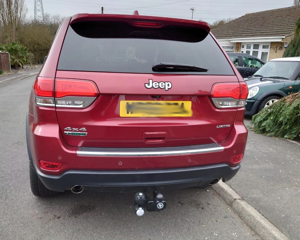 Red Jeep Grand Cherokee fitted with a fixed Tow-Trust Tow Bar