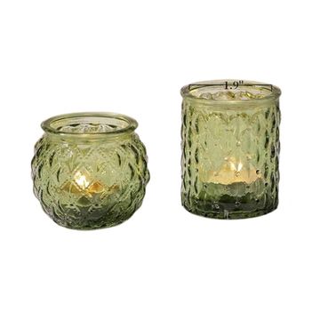 Circular or cylinder shaped green votive candle holders.