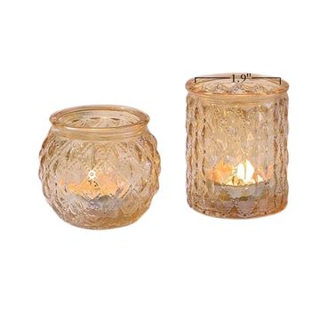 Circular or cylinder shaped gold votive candle holders.