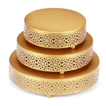Set of 3 different sized golden risers.