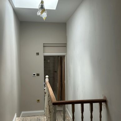 Empty hallway under renovation with natural skylight.
