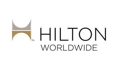 Hilton Worldwide logo with gold and silver design.