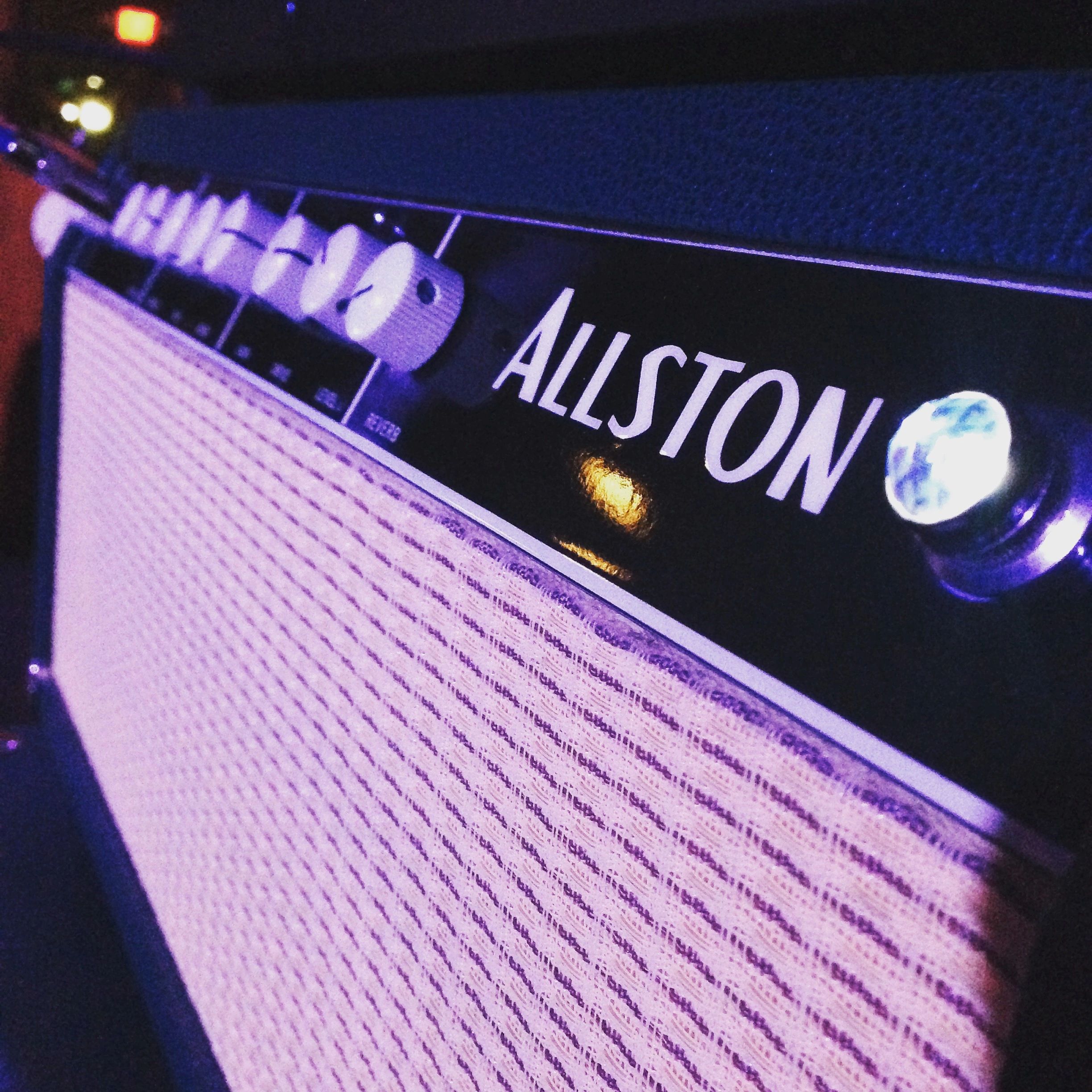 Perspective view of Sam's Allston AOC mark 1 head under blue stage lighting.