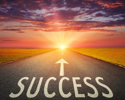 Road leading to success at sunrise.