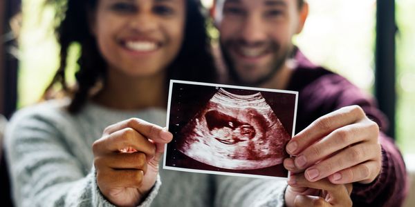 Photo of a couple holding a sonogram picture 