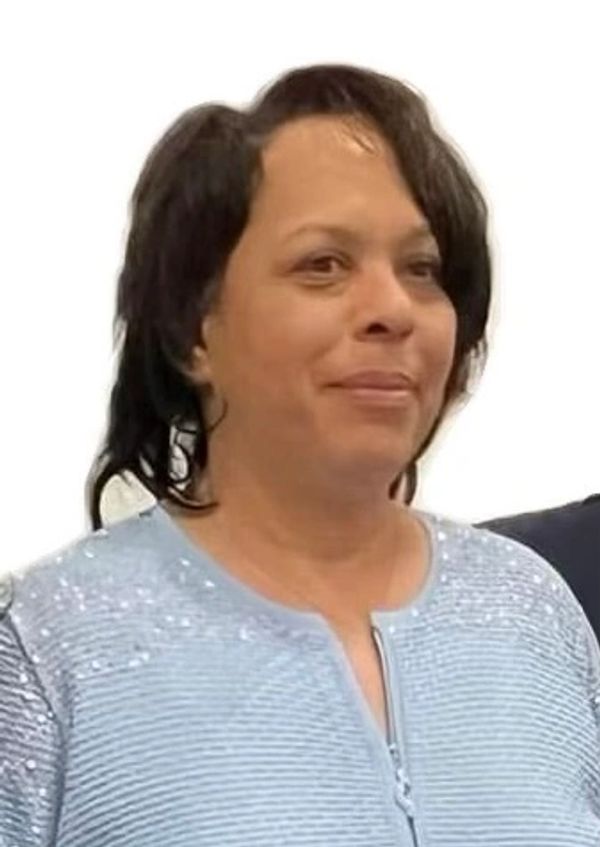 Woman in light blue sequined top.