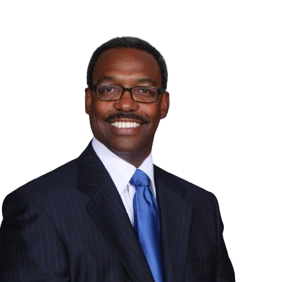 Smiling man in suit with blue tie and glasses.