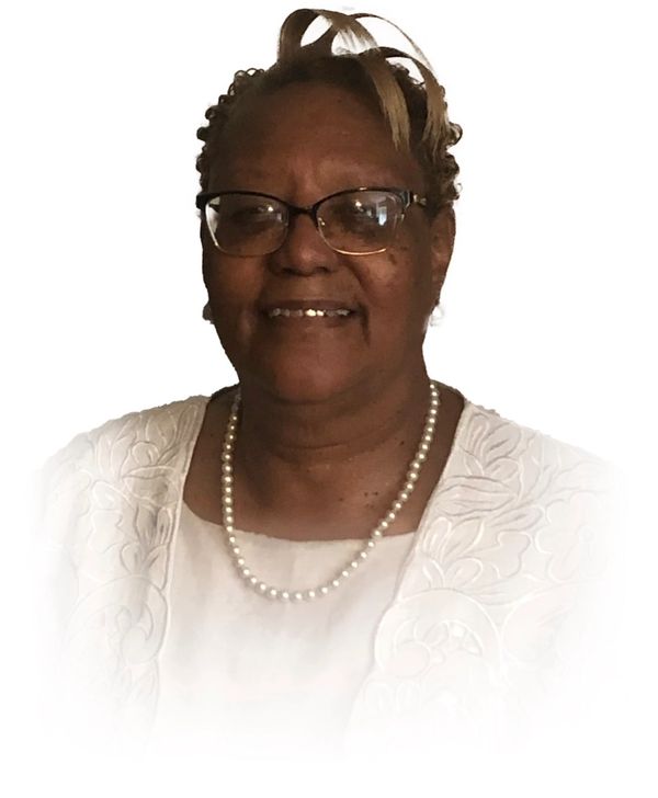 Portrait of a smiling woman wearing glasses and pearls.