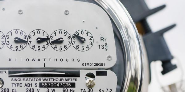 Close-up of an analog electricity meter showing kilowatt hours.