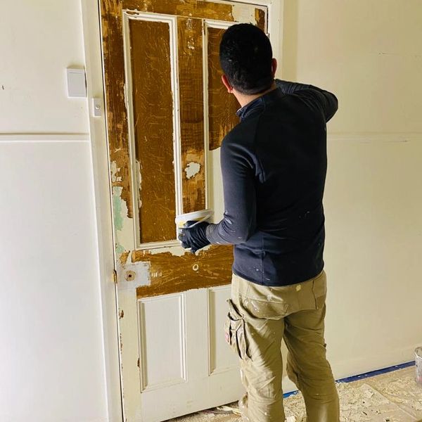 Stripping old paint from door