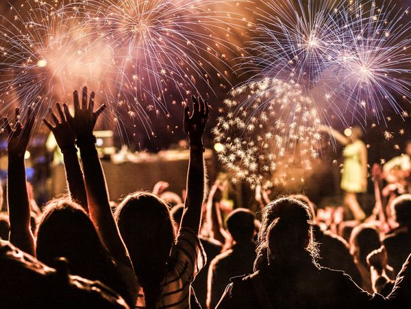 New Year's concept - crowd cheering and fireworks

