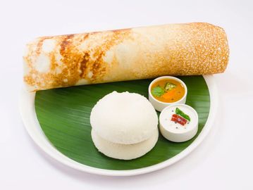 Indian South meal with dosa, idli, and chutneys.