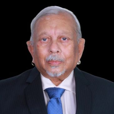 Portrait of an elderly man in formal attire against black background.