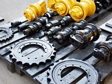 Yellow and black industrial mechanical parts arranged on a pallet.