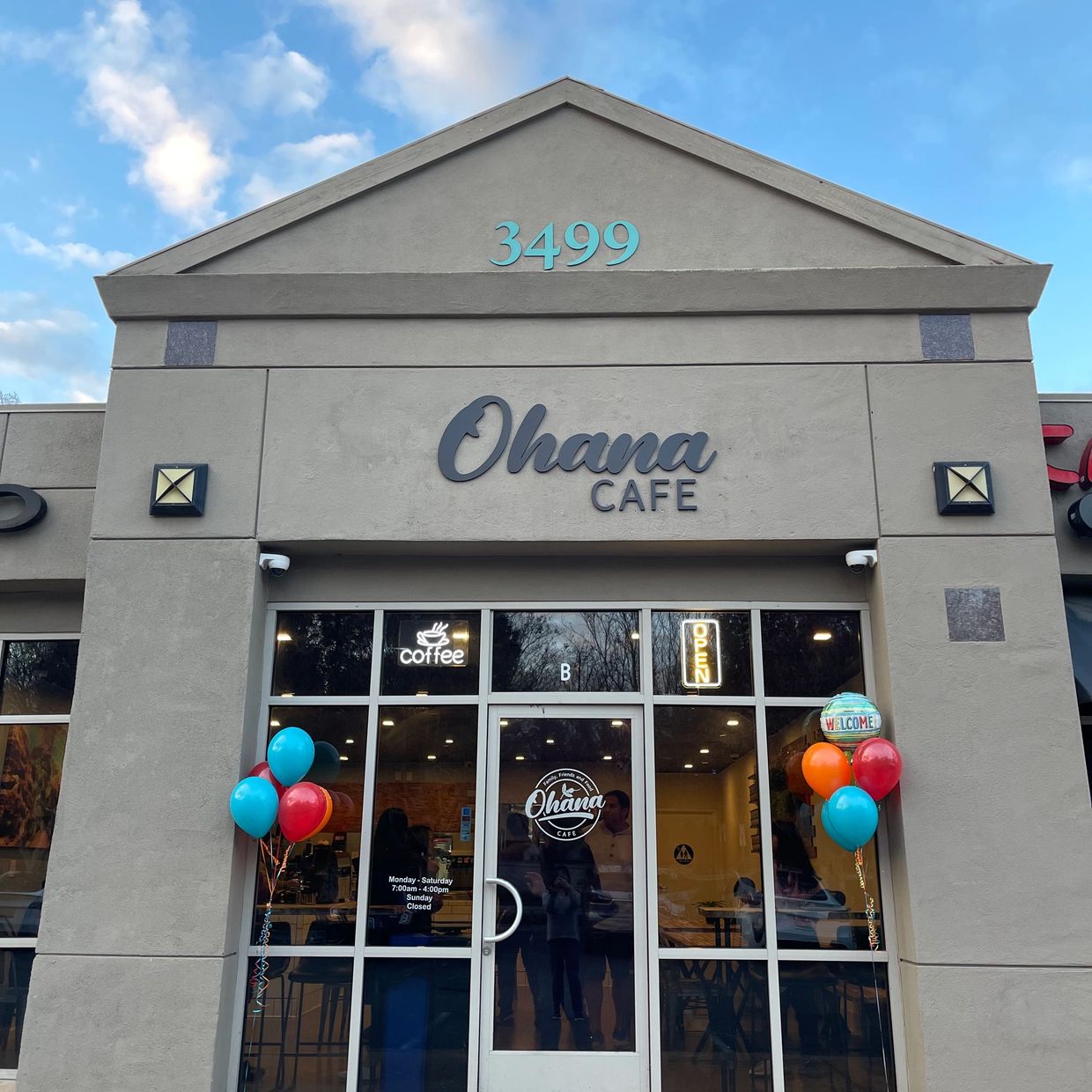 Ohana Cafe storefront with balloons and open sign.