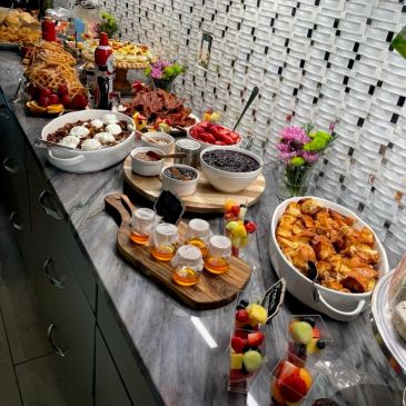 Buffet table with diverse dishes and drinks.