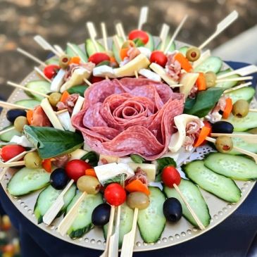 Charcuterie platter with salami arranged as a rose.