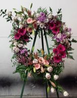 Custom flowers for any occasion. Floral wreath with gerbera daisies, lisianthus, lilies and roses.