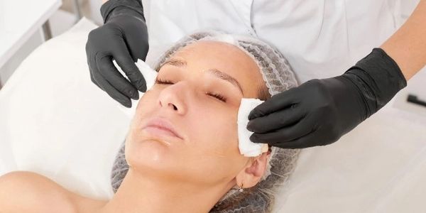 This is the cleansing process during a facial at About Skin Spa in Ocala, FL. This woman is happy.