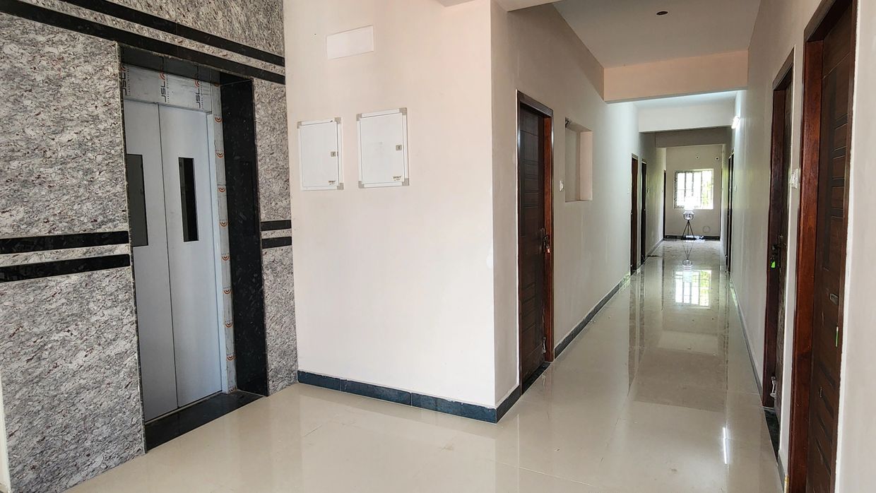 Clean corridor with elevator and doors.