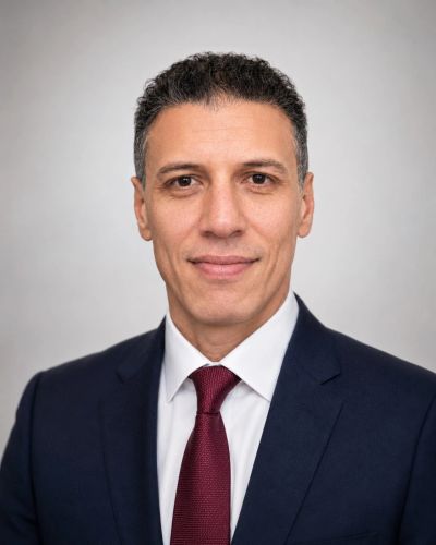 Professional headshot of a man in a suit and tie.