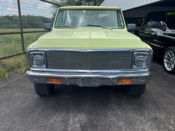 Green vintage SUV parked outdoors.
