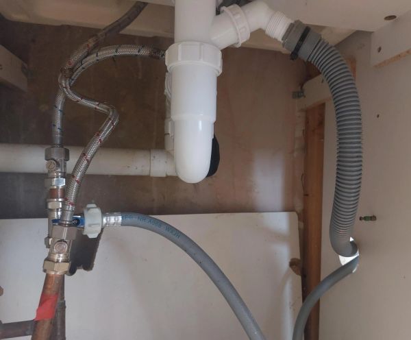 Isolators, appliance connecter and drainage pipes installed for a washing machine in Hertford