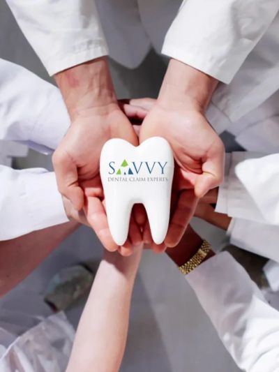 Hands holding a tooth model with Savvy Dental Claim Experts logo.