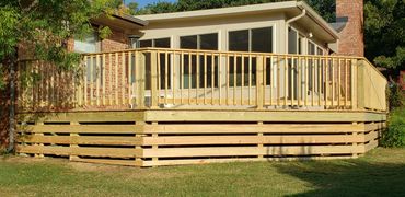 Pressure treated deck with a 45 degree side and fascia going down the front to the grass.