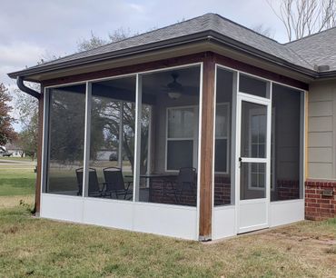White aluminum extruded screen walls, with kick panel, installed beneath existing patio.