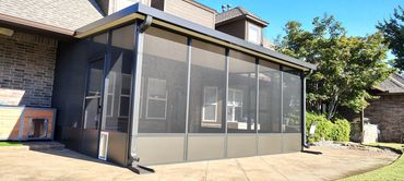 Aluminum screen room in bronze with kick panels at the bottom and a doggy door.
