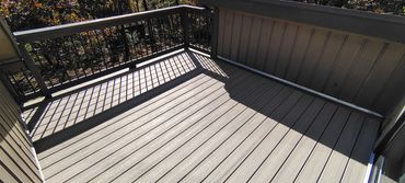A composite deck with Trex Enhanced Honey Grove decking.