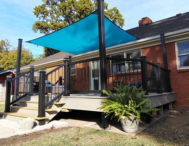 A composite deck with Trex Enhanced Tiede Pool decking and a shade sail.